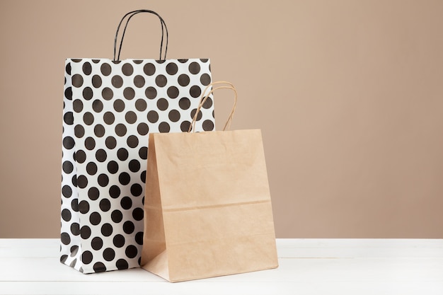 Arrangement of shopping bags on beige background