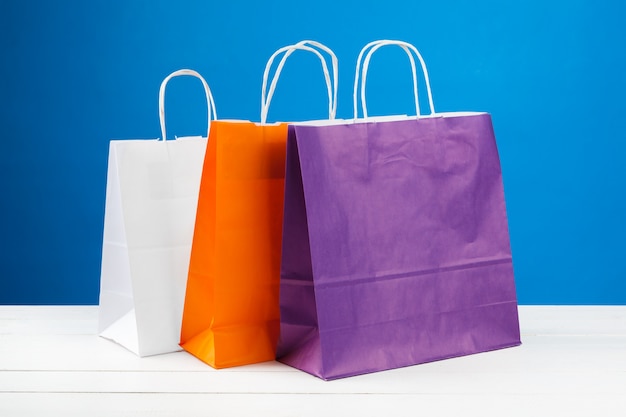 Arrangement of shopping bags on blue 