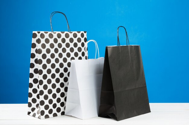 Arrangement of shopping bags on blue 