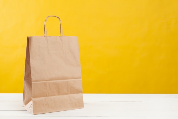 Arrangement of shopping bags on bright yellow 