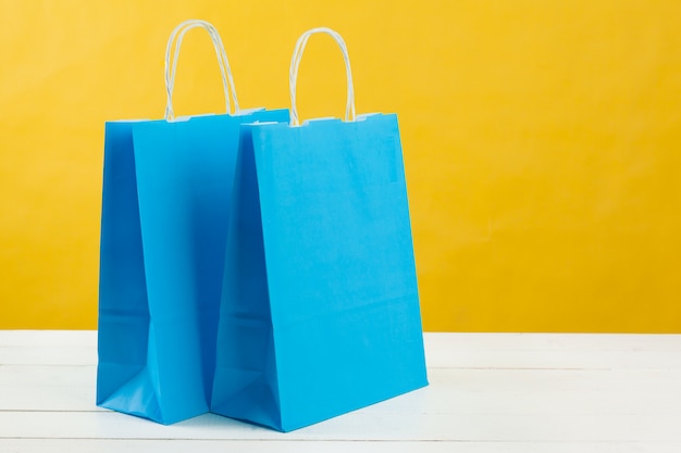 Arrangement of shopping bags on bright yellow 