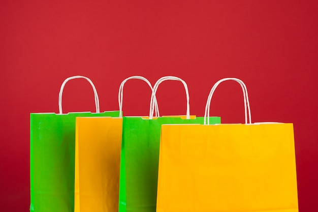 Arrangement of shopping bags on red 