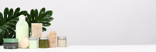 Arrangement of skin care products with palm leaves