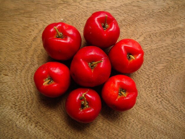 arrangement of some acerolas on a wooden board