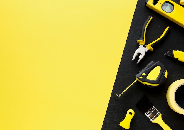 Photo arrangement of tools with yellow copy space background