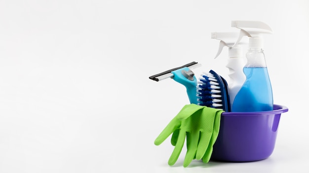 Arrangement with cleaning products in purple basin