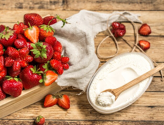 arrangement with fresh strawberries on wooden table