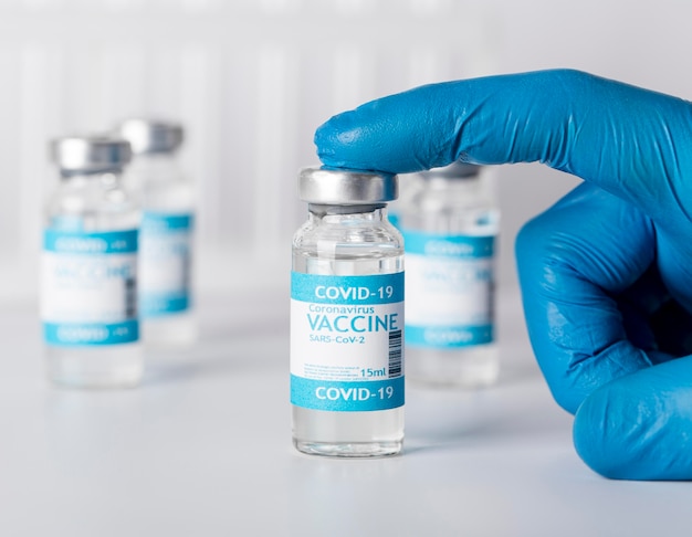 Photo arrangement with vaccination bottle in lab