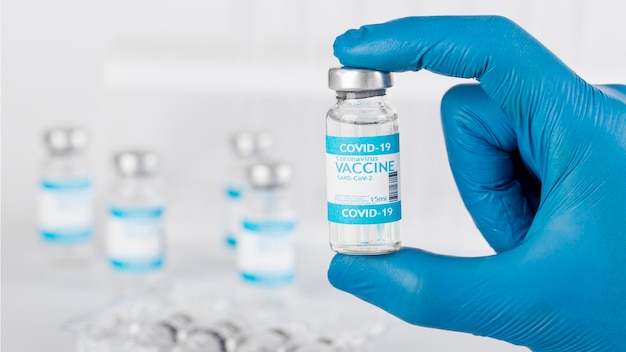 Photo arrangement with vaccination bottle in lab