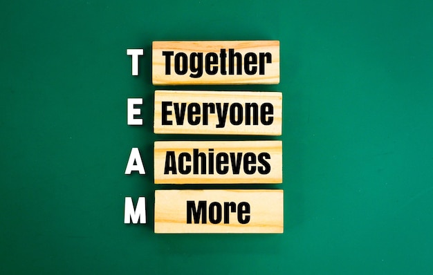 arrangement of wood with the word TEAM and the meaning of team Together Everyone Achieves More