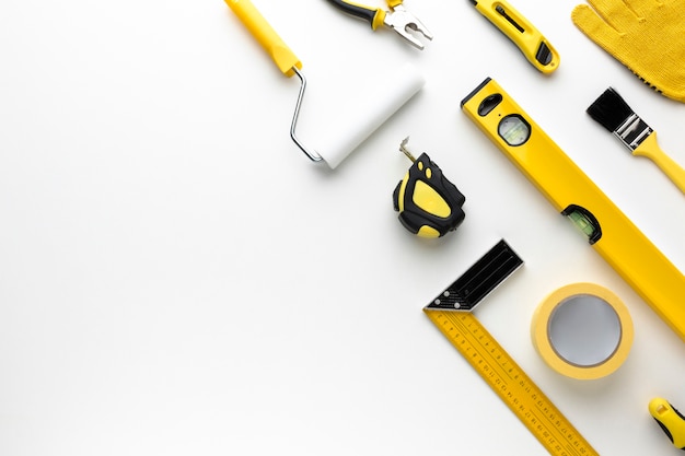 Photo arrangement of yellow repair tools with copy space