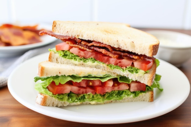 Arranging half of a blt on a white plate