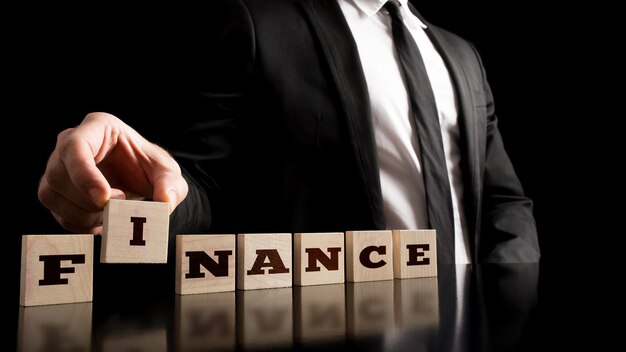 Arranging Small Wooden Blocks with word Finance