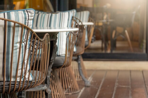 An array of stylish metallic armchairs and marble tables