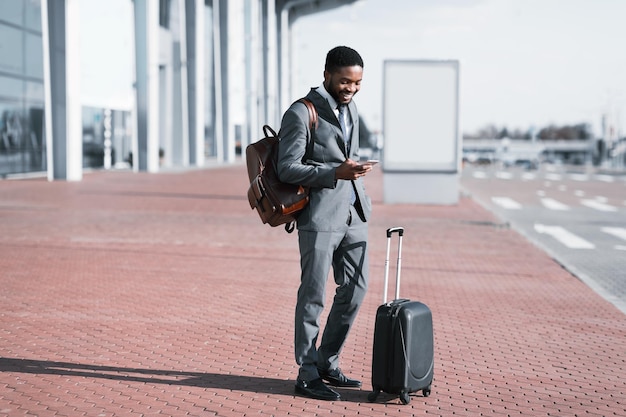 Arrival at Airport Businessman Checking Email On Mobile Phone