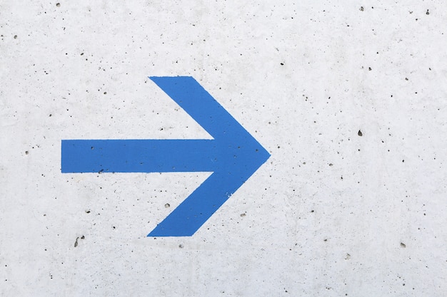 Arrow on concrete wall background