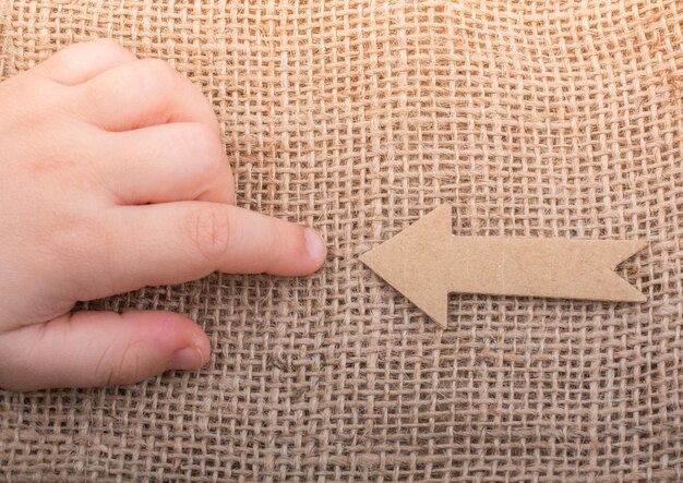 Arrow cut out of brown paper