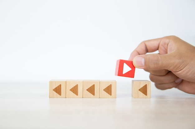 Arrow icon on cube wooden toy block with pointing to opposite directions.