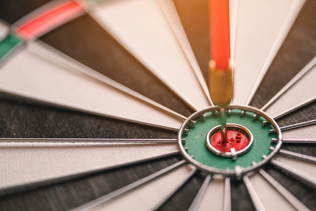Photo arrow, target, business, success, planned, planning concept. the red arrow in the middle of the dart board shown success. the concept of setting business goals possible business planning.
