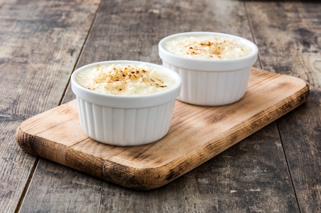Arroz con leche Rice pudding with cinnamon on wood