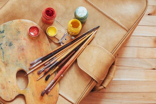 art brush and colored inks in cans