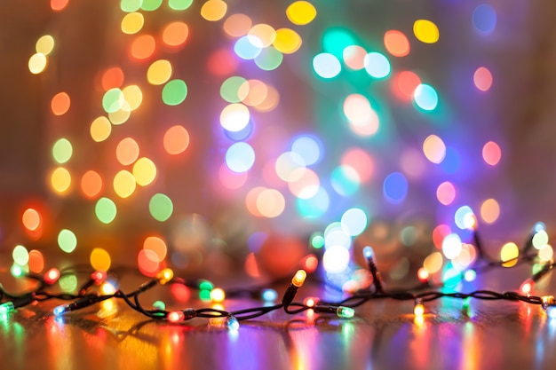 Art Colorful lights on a wooden background. Christmasl garland