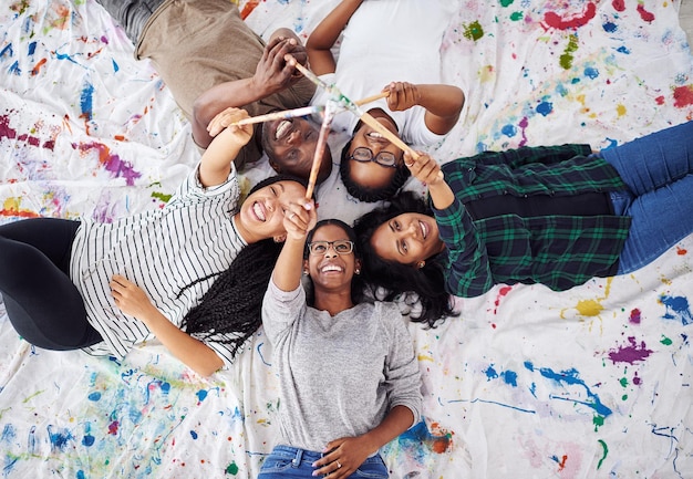 Photo art makes you look at the world differently shot of a group of artists holding their paint brushes together