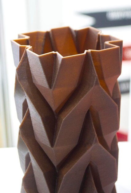 Art object vase printed on d printer from melted brown plastic with addition waste coffee model made