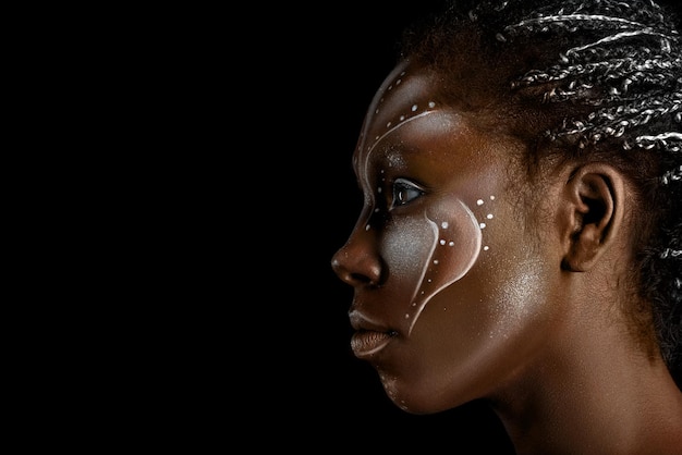 Art photo of africal woman with tribal ethnic paintings on her face