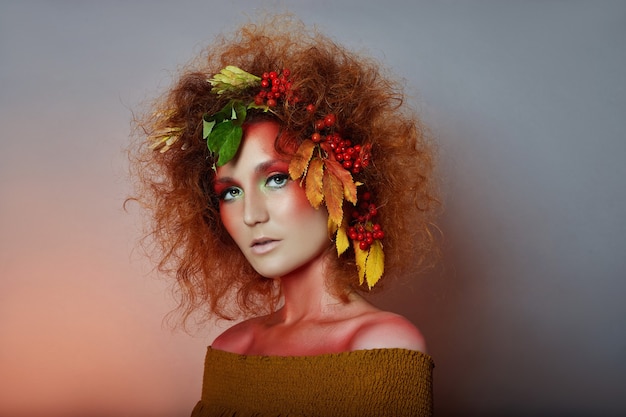 Art portrait of woman with leaves in her hair