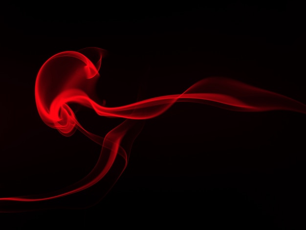 Art of red smoke abstract on black background, fire , darkness concept