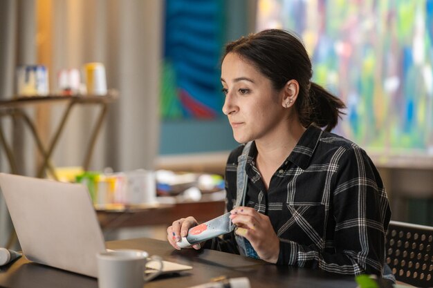 An art store employee sits in front of a computer and reads
orders to be packed processed checks sto