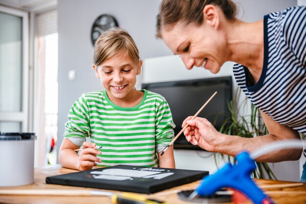 Art teacher helping a student with painting