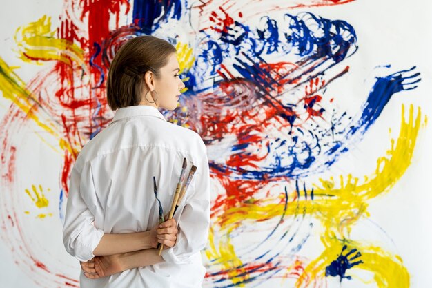 Art therapy hand painting woman with colorful wall