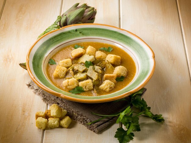 Artichoke soup with toasted sliced bread vegetarian food