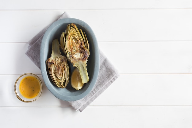 Artichokes and lemons on the plate. This product has one of the highest antioxidant capacities