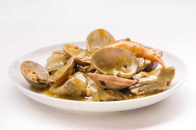 Artichokes with clams and prawns typical traditional Spanish food for Christmas and New Year