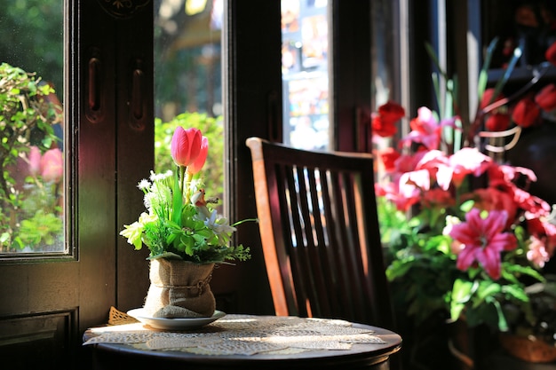 Artificial flowers in brown sack vase on the table