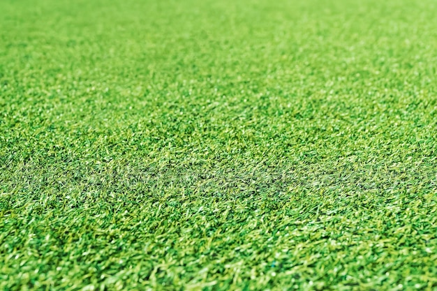 Artificial green grass, perspective, stretching into the distance