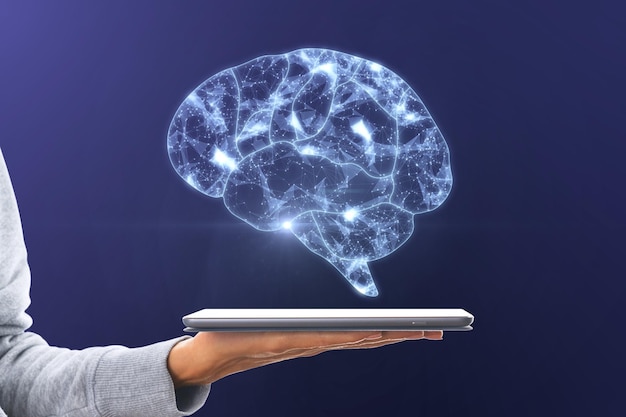 Artificial intelligence and machine learning concept with digital glowing human brain symbol above digital tablet on woman palm on dark background