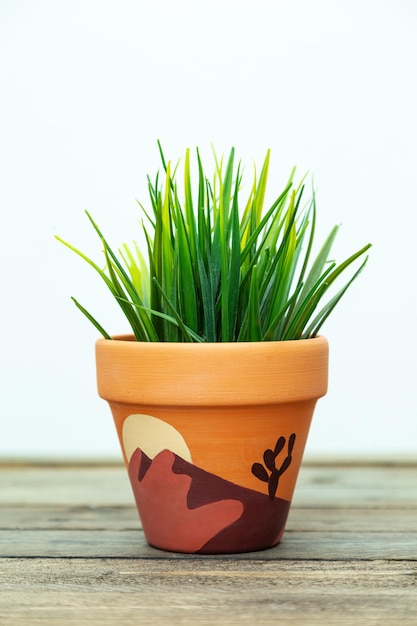 Artificial plant in a clay terracotta pot