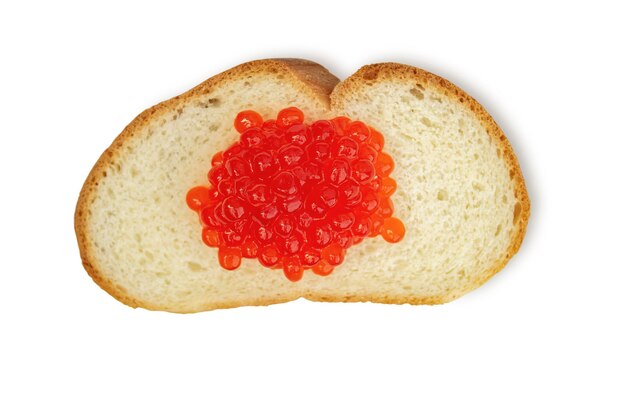 Artificial red caviar lies on a piece of white bread on a white background