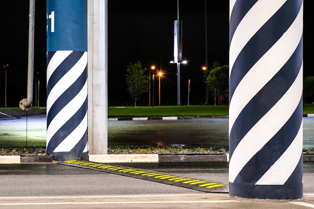 Artificial road roughness speed bump. Yellow bright squares are applied to the obstacle to attract the attention of drivers.