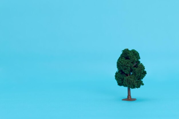 Artificial trees to scale on a blue background. Isolated trees.