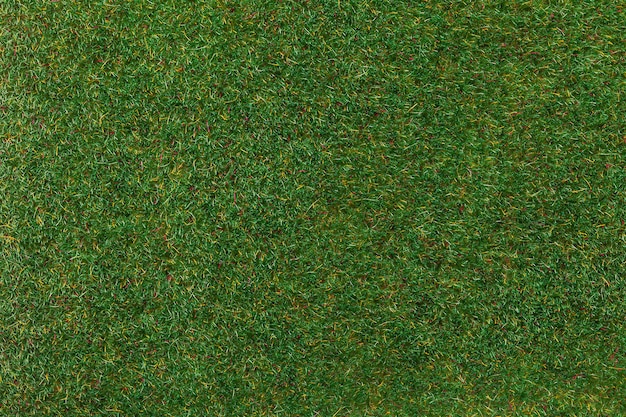 Tappeto erboso artificiale per campo sportivo e decorare il cortile, sfondo macro. texture di tappeto di erba verde, sfondo.