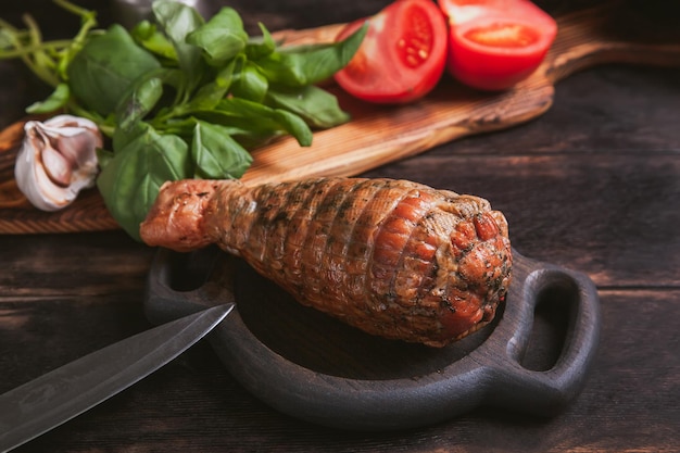 Artisan ham made from turkey meat boiled and smoked with the\
addition of chicken fillet still life with ham in the form of a\
turkey leg