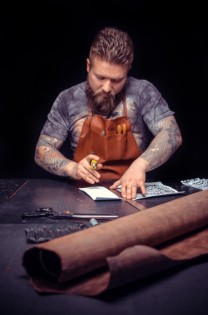 Artisan of leather keen on one's business at his leather shop