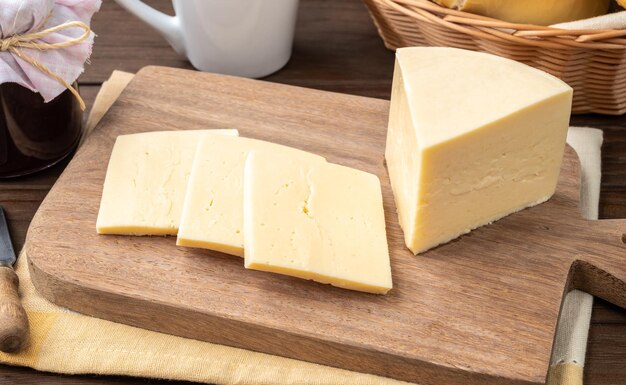 Artisanal Alagoa cheese from Minas Gerais Brazil over a wooden board with coffee and bread