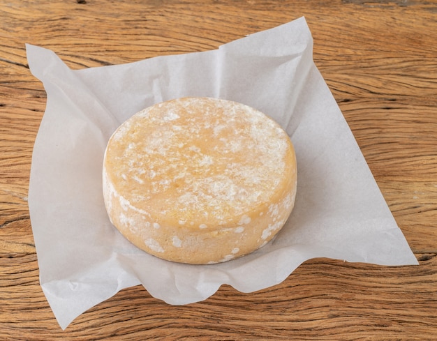 Artisanal Canastra cheese from Minas Gerais, Brazil over paper.