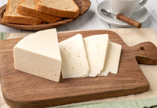 Artisanal fresh Canastra cheese with bread over wooden board